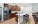 Modern kitchen with stainless steel appliances, stylish countertops, a center island, and dark wood cabinets at 1027 Eagle Tree Ln, Sanford, FL 32771
