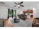 Spacious living room with hardwood floors, a ceiling fan, and sliding glass doors leading to the outdoor patio at 1027 Eagle Tree Ln, Sanford, FL 32771