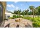 Back patio with brick pavers and a fire pit at 1027 Eagle Tree Ln, Sanford, FL 32771