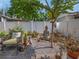 Backyard featuring a Buddha statue, stone pavers, gravel, privacy fence, and lush landscaping at 1041 N Fern Creek Ave, Orlando, FL 32803