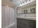 Bathroom featuring a large, framed mirror and a clean, white shower at 1041 N Fern Creek Ave, Orlando, FL 32803