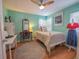 Bright bedroom features a bed, desk, chair and a sewing model near the window at 1041 N Fern Creek Ave, Orlando, FL 32803