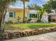Charming yellow bungalow with a stone-lined garden and inviting front porch at 1041 N Fern Creek Ave, Orlando, FL 32803