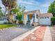 Charming home boasts a well-manicured lawn, a brick driveway, and inviting front porch at 1041 N Fern Creek Ave, Orlando, FL 32803