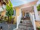 Inviting front porch with stone steps, white railings and cozy seating area at 1041 N Fern Creek Ave, Orlando, FL 32803