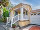Charming front porch with white railings, stone steps and adjacent garage at 1041 N Fern Creek Ave, Orlando, FL 32803