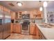 Well-equipped kitchen boasts stainless steel appliances and ample maple cabinetry at 1041 N Fern Creek Ave, Orlando, FL 32803