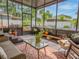Relaxing screened porch features a seating area, potted plants, and views of the landscaped backyard at 1041 N Fern Creek Ave, Orlando, FL 32803