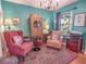 Cozy sitting room with two plush armchairs, colorful rug, and eclectic decor at 1041 N Fern Creek Ave, Orlando, FL 32803