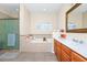 Bathroom features a soaking tub, a glass shower, wood cabinets, dual sinks, and large framed mirror at 1046 Morris Ave # 1046, Orlando, FL 32803