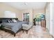 Bright bedroom features neutral walls, ceramic tile floor, ceiling fan, and a sliding glass door with balcony access at 1046 Morris Ave # 1046, Orlando, FL 32803