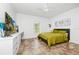 White bedroom featuring ceramic tile floors, a ceiling fan, minimal wall art, and a large TV on a chest of drawers at 1046 Morris Ave # 1046, Orlando, FL 32803