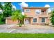 Charming two-story home featuring stucco siding, arched windows, and a well-manicured front yard at 1046 Morris Ave # 1046, Orlando, FL 32803