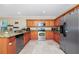 Kitchen with stainless steel appliances, granite countertops, oak cabinets and travertine floors at 1046 Morris Ave # 1046, Orlando, FL 32803