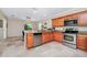 Open kitchen with stainless steel appliances, oak cabinets, granite countertops, and a dining area at 1046 Morris Ave # 1046, Orlando, FL 32803