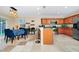 Spacious kitchen featuring a breakfast bar, stainless steel appliances, and a dining area with a modern light fixture at 1046 Morris Ave # 1046, Orlando, FL 32803