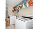 Functional laundry room with modern appliances, overhead storage, and a clean, organized layout at 1046 Morris Ave # 1046, Orlando, FL 32803