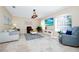 Bright living room featuring tile flooring, a decorative ceiling light, and modern furniture at 1046 Morris Ave # 1046, Orlando, FL 32803
