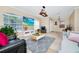 Open-concept living room with large windows, tile flooring, and a modern entertainment setup at 1046 Morris Ave # 1046, Orlando, FL 32803