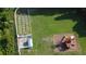 Aerial view of the backyard with a playground, garden area, and lush green grass at 10809 Arrowtree Blvd, Clermont, FL 34715
