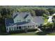Aerial view of the property showcasing its spacious layout, covered porch, and lush green yard at 10809 Arrowtree Blvd, Clermont, FL 34715