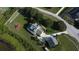 An aerial view shows a home with a private pool, spacious driveway, and a large, well-maintained yard with mature trees at 10809 Arrowtree Blvd, Clermont, FL 34715