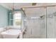 Elegant bathroom showcases a soaking tub, a glass shower, and bright natural light at 10809 Arrowtree Blvd, Clermont, FL 34715