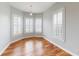 Sunlit bedroom featuring hardwood floors, bay windows with white shutters, and elegant trim at 10809 Arrowtree Blvd, Clermont, FL 34715