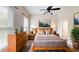 Bright bedroom with a ceiling fan, hardwood floors, and coordinated decor, creating a relaxing retreat at 10809 Arrowtree Blvd, Clermont, FL 34715