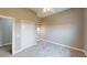 Neutral bedroom with gray carpet, white trim and closet door, plus accent wallpaper at 10809 Arrowtree Blvd, Clermont, FL 34715