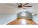 Bonus room with hardwood floors, large ceiling fan and bright windows at 10809 Arrowtree Blvd, Clermont, FL 34715