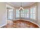 Dining area featuring hardwood floors, plantation shutters, and an elegant chandelier at 10809 Arrowtree Blvd, Clermont, FL 34715