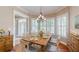 Charming dining room with rustic wooden table, natural light from shuttered windows, and elegant decor at 10809 Arrowtree Blvd, Clermont, FL 34715