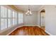 Bright dining room featuring hardwood floors, plantation shutters, and a chandelier at 10809 Arrowtree Blvd, Clermont, FL 34715