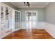 Open entryway with hardwood floors and french doors leading to a spacious room at 10809 Arrowtree Blvd, Clermont, FL 34715
