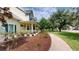 Charming home featuring a welcoming porch and manicured landscape with flowering plants at 10809 Arrowtree Blvd, Clermont, FL 34715