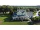 A well-maintained home with a large front porch, manicured lawn, and mature trees, exuding curb appeal in a serene setting at 10809 Arrowtree Blvd, Clermont, FL 34715