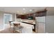 Compact kitchen with stainless steel appliances, breakfast bar, and tile backsplash for easy maintenance at 10809 Arrowtree Blvd, Clermont, FL 34715