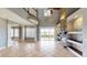 Spacious living room with stone fireplace, tile floors, and lots of natural light at 10809 Arrowtree Blvd, Clermont, FL 34715