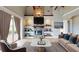 Stylish living room with a stone fireplace, built-in shelves, and comfortable seating at 10809 Arrowtree Blvd, Clermont, FL 34715