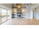 Bright living room features a stone fireplace, built-in shelving, and sliding doors to the outdoor deck at 10809 Arrowtree Blvd, Clermont, FL 34715