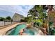Backyard pool with rock waterfall feature and tropical foliage offers a luxurious outdoor oasis at 10809 Arrowtree Blvd, Clermont, FL 34715