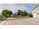 Beautiful pool area with black metal fence, mature trees, and rock features at 10809 Arrowtree Blvd, Clermont, FL 34715