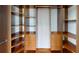 Spacious walk-in closet with custom shelving and drawers, providing ample storage for your wardrobe at 10809 Arrowtree Blvd, Clermont, FL 34715