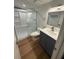 Updated bathroom features a sleek vanity, sink, toilet, and glass-enclosed shower at 118 S Halifax Ave # 409, Daytona Beach, FL 32118