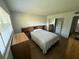Spacious bedroom with wood floors, natural light, closet, and matching furnishings at 118 S Halifax Ave # 409, Daytona Beach, FL 32118