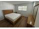Well-lit bedroom with wood floors, furnishings, and a window at 118 S Halifax Ave # 409, Daytona Beach, FL 32118