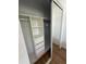 Bedroom closet with shelving, hanging space, drawers and mirrored doors at 118 S Halifax Ave # 409, Daytona Beach, FL 32118
