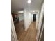 Bright hallway featuring wood flooring, white walls, and white doors at 118 S Halifax Ave # 409, Daytona Beach, FL 32118
