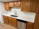 Updated kitchen with stainless steel dishwasher, under mount sink and neutral toned cabinets at 118 S Halifax Ave # 409, Daytona Beach, FL 32118
